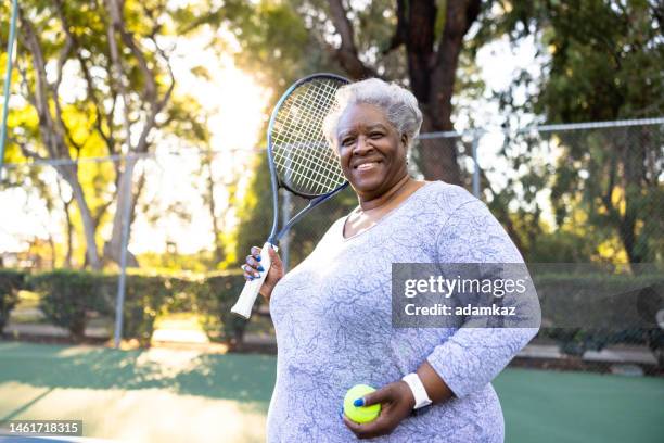 senior black woman playing tennis - fat old women stock pictures, royalty-free photos & images