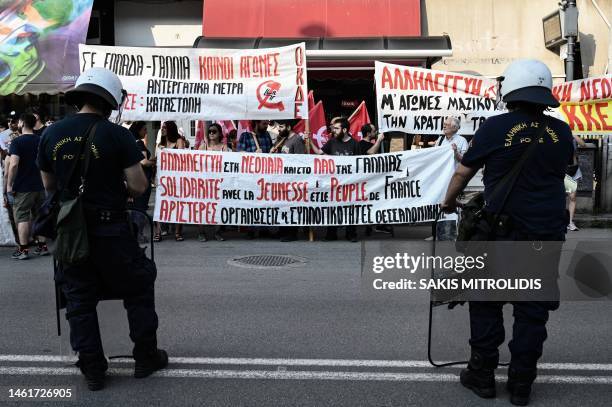 Demonstrators hold banners outside the Institute and Consulate of France, in Thessaloniki on July 3 during a protest after a 17-year-old man was...