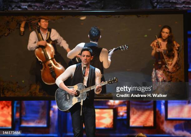 Steve Kazee performs on stage with the case of 'Once the Musical' onstage at the 66th Annual Tony Awards at The Beacon Theatre on June 10, 2012 in...