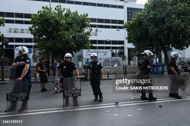 Policemen stand in position outside the Institute and Consulate of France, in Thessaloniki on July 3 where demonstrators gather to protest after a...