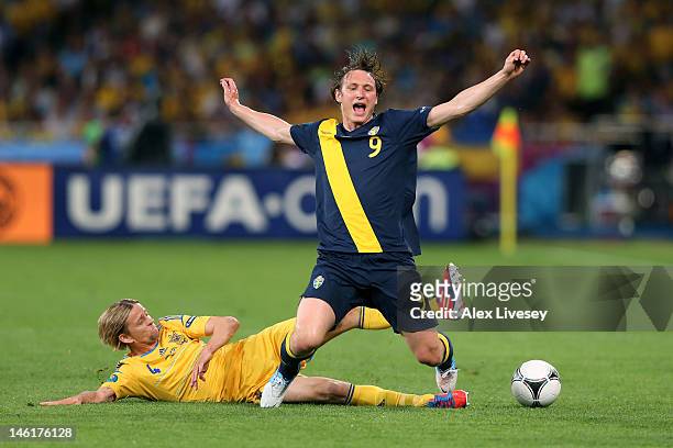 Anatoliy Tymoshchuk of Ukraine tackles Kim Kallstrom of Sweden during the UEFA EURO 2012 group D match between Ukraine and Sweden at The Olympic...