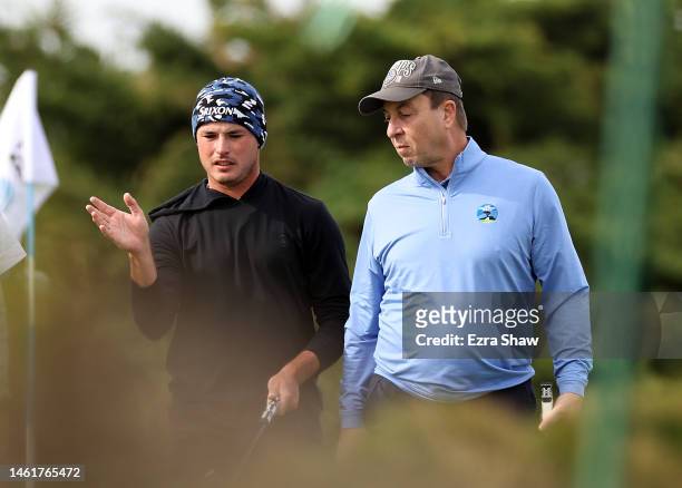 Brent Grant of the United States and Joe Lacob wait to putt on the 15th green during the first round of the AT&T Pebble Beach Pro-Am at Monterey...