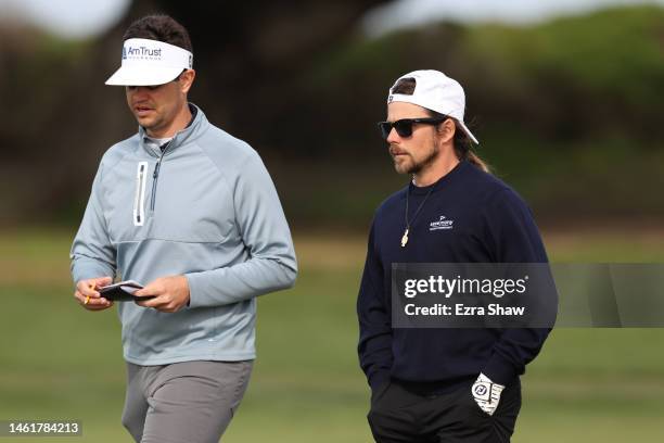 Beau Hossler and Lukas Nelson of the United States walk on the 13th green during the first round of the AT&T Pebble Beach Pro-Am at Monterey...