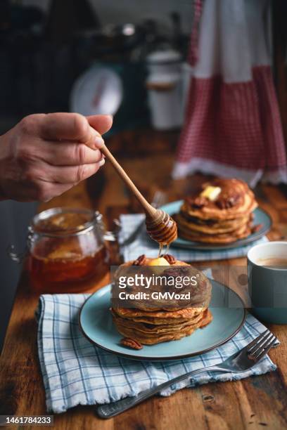 sweet potato pancakes with butter, pecans and maple syrup - sweet potato pancakes stock pictures, royalty-free photos & images