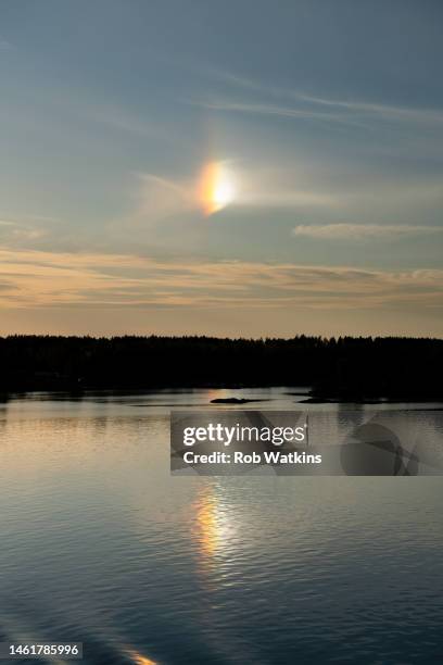 sun dogs (sundog) atmospheric effect from ice crystals in the atmosphere over baltic sea ferry åland islands between finland and sweden - sundog stock pictures, royalty-free photos & images
