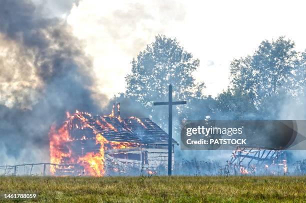 burning mock-up of farm buildings. - cross fire stock pictures, royalty-free photos & images