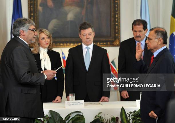 Paraguay's President and President pro tempore of the South American Nations Union , Fernando Lugo , takes the oath to the new UNASUR Secretary...