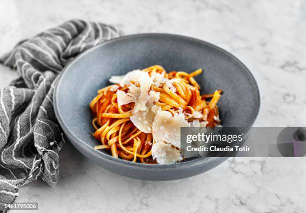 bowl of fettuccini with tomato sauce and parmesan on white, marble background - dish towel stock pictures, royalty-free photos & images