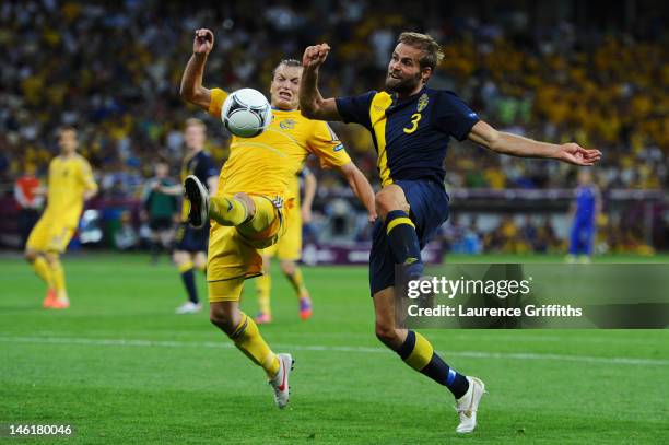 Oleh Husyev of Ukraine and Olof Mellberg of Sweden compete for the ball during the UEFA EURO 2012 group D match between Ukraine and Sweden at The...