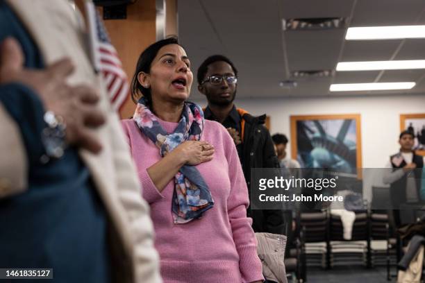 Immigrants sing the U.S. National anthem at a naturalization ceremony on February 01, 2023 in Newark, New Jersey. Thirty-five people became American...