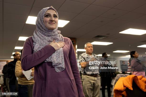 An immigrant from Jordan recites the Pledge of Allegiance at a naturalization ceremony on February 01, 2023 in Newark, New Jersey. Thirty-five people...