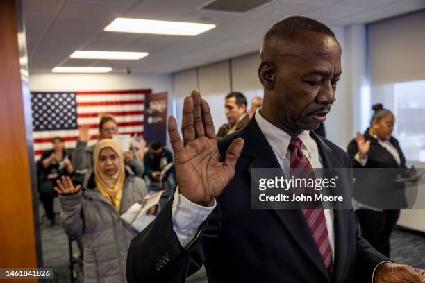 Immigrants take the oath of allegiance to the United States during a naturalization ceremony on February 01, 2023 in Newark, New Jersey. Thirty-five...