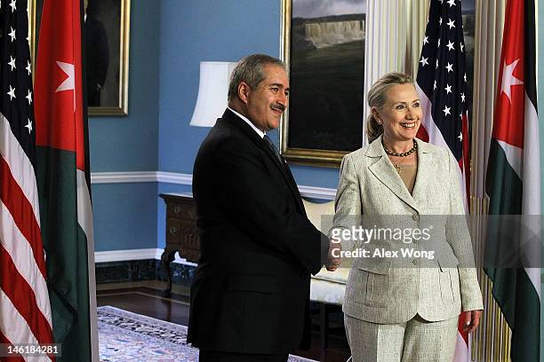 Secretary of State Hillary Clinton and Jordanian Foreign Minister Nasser Judeh shake hands after they spoke to the media prior to their meeting at...