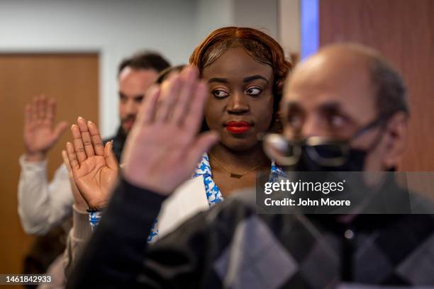 Immigrants take the oath of allegiance to the United States during a naturalization ceremony on February 01, 2023 in Newark, New Jersey. Thirty-five...