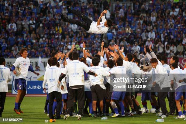 Head coach Hiroshi Jofuku of Ventforet Kofu is tossed into the air as the team celebrates the team's 2-2 draw confirming the promotion to the J1...