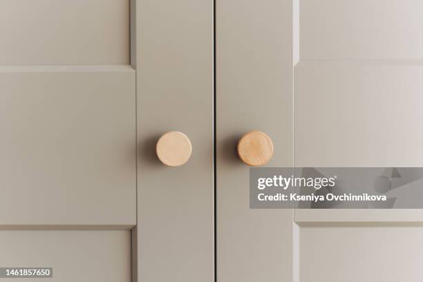 two crystal handles on white wooden cabinet doors - cabinet stock pictures, royalty-free photos & images