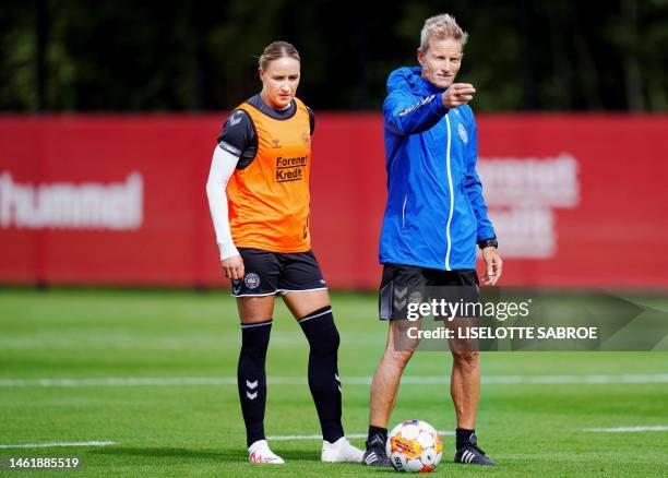 Denmark's head coach Lars Sondergaard gestures next to Denmark's Sanne Troelsgaard during a training session of Denmark's women national team in...