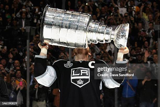 Captain Dustin Brown of the Los Angeles Kings kisses the Stanley Cup after his team defeated the New Jersey Devils 6-1 in Game Six of the 2012...