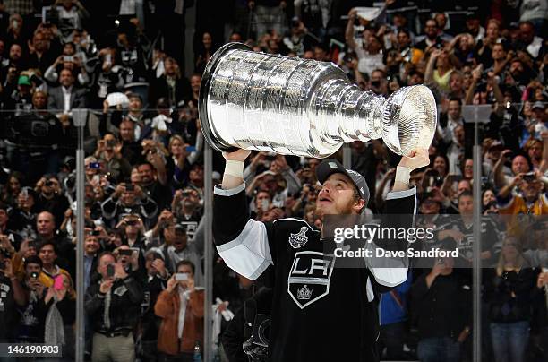 Captain Dustin Brown of the Los Angeles Kings lifts the Stanley Cup after his team defeated the New Jersey Devils 6-1 in Game Six of the 2012 Stanley...