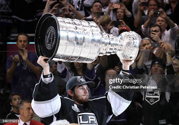 Goaltender Jonathan Quick of the Los Angeles Kings holds up the Stanley Cup after the Kings defeat the New Jersey Devils 6-1 to win the Stanley Cup...