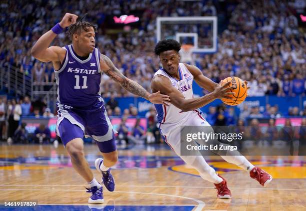 Joseph Yesufu of the Kansas Jayhawks drives against Keyontae Johnson of the Kansas State Wildcats during the game at Allen Fieldhouse on January 31,...