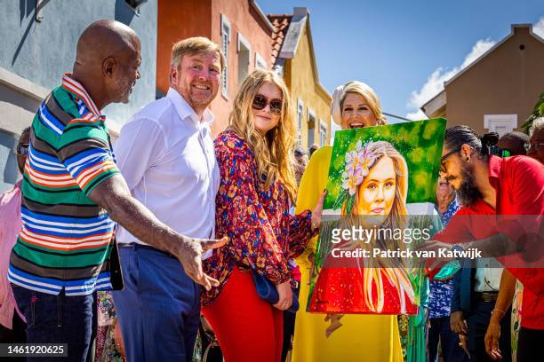 King Willem-Alexander of The Netherlands, Princess Amalia of The Netherlands and Queen Maxima of The Netherlands receive a painting during a walk...