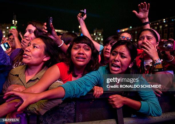 Fans of Canadian singer Justin Bieber cry during a concert at the Zocalo square, in Mexico City, on June 11, 2012. AFP PHOTO / RONALDO SCHEMIDT