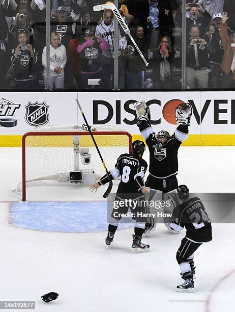 Drew Doughty, Jonathan Quick and Colin Fraser of the Los Angeles Kings celebrate the Kings 6-1 victory as they win the Stanley Cup series 4-2 after...