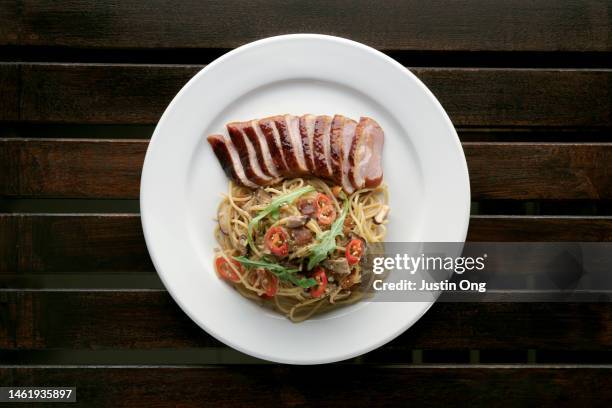 duck breast pasta with chili pepper - gourmet duck dish stock pictures, royalty-free photos & images