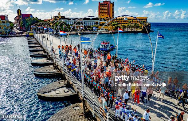 King Willem-Alexander of The Netherlands, Queen Maxima of The Netherlands and Princess Amalia of The Netherlands walk over the Pontjesbridge during...