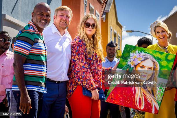 King Willem-Alexander of The Netherlands, Princess Amalia of The Netherlands and Queen Maxima of The Netherlands receive a painting of Princess...