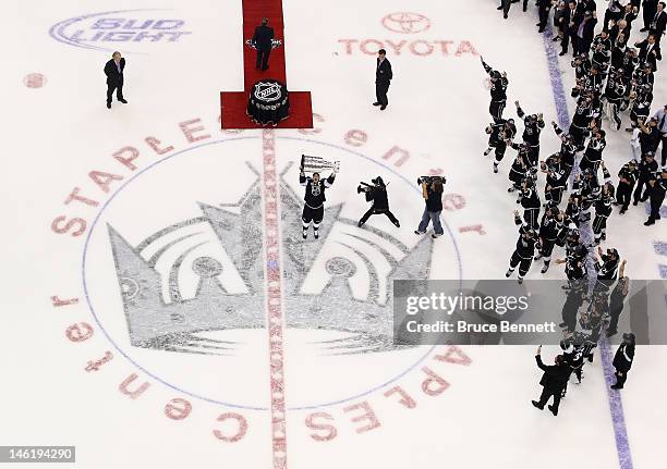 Captain Dustin Brown of the Los Angeles Kings holds up the Stanley Cup after the Kings defeated the New Jersey Devils 6-1 to win the Stanley Cup...