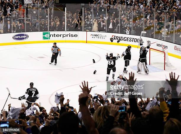 Drew Doughty, Jonathan Quick and Colin Fraser of the Los Angeles Kings celebrate the Kings 6-1 victory as they win the Stanley Cup final series 4-2...