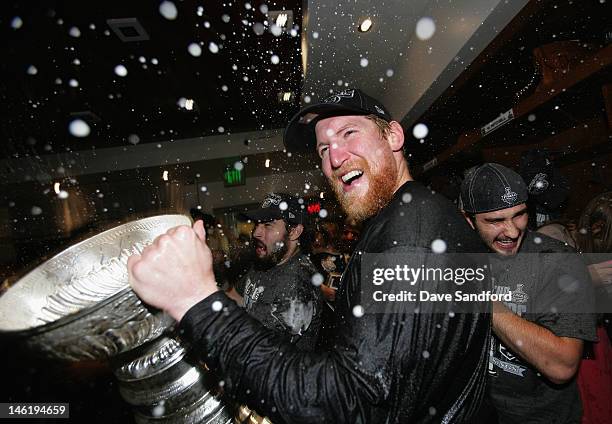 Matt Greene of the Los Angeles Kings celebrates with the Stanley Cup in the locker room after the Los Angeles Kings defeated the New Jersey Devils...