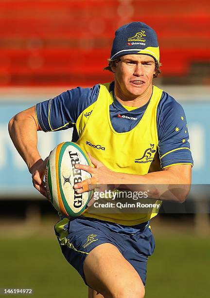 Berrick Barnes of the Wallabies runs with the ball during an Australian Wallabies training session at Visy Park on June 12, 2012 in Melbourne,...