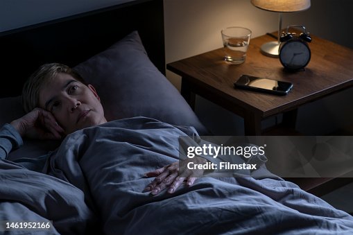 Depressed senior woman lying in bed cannot sleep from insomnia Depressed senior woman lying in bed cannot sleep from insomnia