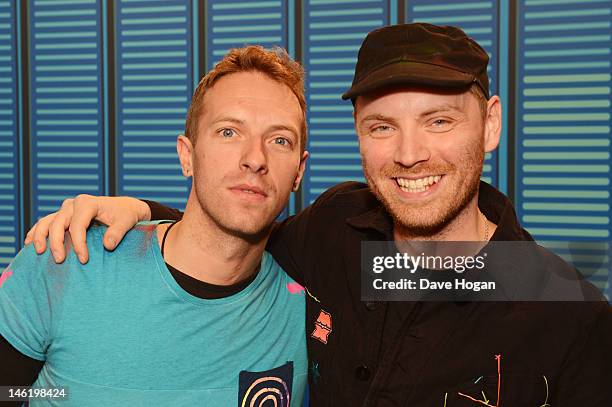 Chris Martin and Jonny Buckland of Coldplay pose in a studio backstage at Wembley Stadium during the Capital FM Summertime Ball on June 9, 2012 in...