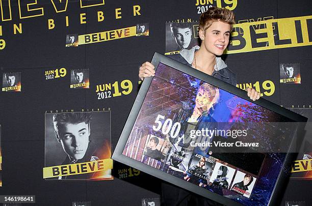 Singer Justin Bieber handling a recognition for more than 500,000 sold copies of his catalog only in Mexico during a press conference and photocall...