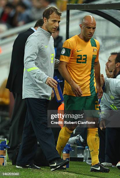 Mark Bresciano of Australia is taken from the field with an injury during the FIFA World Cup Asian Qualifier match between the Australian Socceroos...