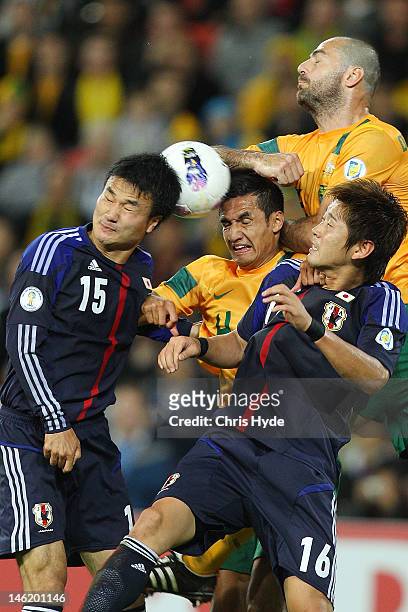Tim Cahill of Australia and Yasuyuki Konno of Japan head the ball during the FIFA World Cup Asian Qualifier match between the Australian Socceroos...