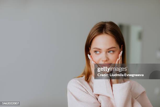 beautiful young woman in pink bathrobe posing in massage cabinet. - glatte oberfläche stock-fotos und bilder