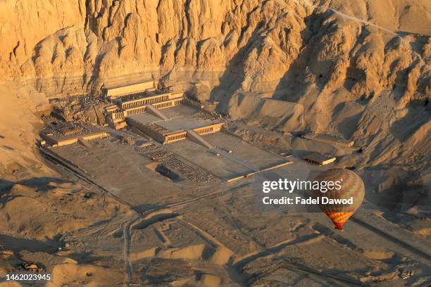 In an aerial view, a hot air balloon flies over the mortuary temple of Hatshepsut along the West Bank on February 2, 2023 in Luxor, Egypt.
