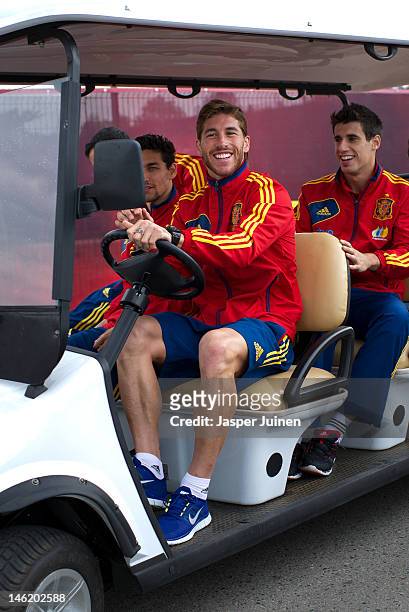 Sergio Ramos of Spain steers a golf cart over the hotel premises with his teammate Javi Martinez and Jesus Navas during the UEFA EURO 2012...