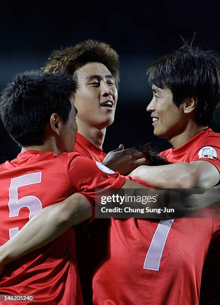 Kim Bo-Kyung of South Korea celebrates after scoring a goal with his team mates Koo Ja-Cheol and Lee Dong-Gook during the FIFA World Cup Asian...