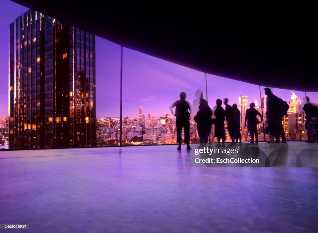 People watching projection of skyline of New York on a large curved screen