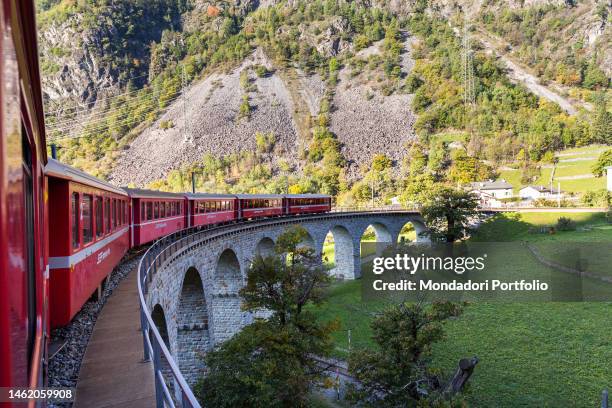 The passage of the Red Train of Bernina on the section of the Brusio viaduct, a helical-shaped stone bridge located in the Canton of Grisons. Brusio...
