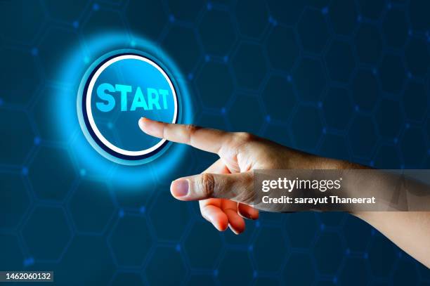 young man's finger pressing the start button the idea of starting something new - new challenge stock pictures, royalty-free photos & images