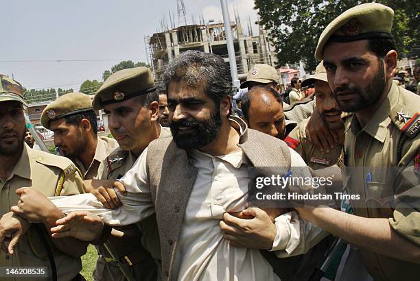 Senior separatist leader Nayeem Khan detained by police during a protest on June 12, 2012 in Srinagar, India. Several separatist leaders were leading...