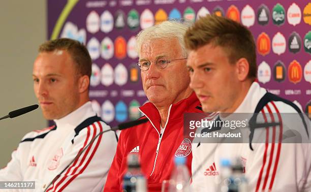 In this handout image provided by UEFA, Lars Jacobsen, Morten Olsen the coach of Denmark and Nicklas Bendtner face the media during a UEFA EURO 2012...