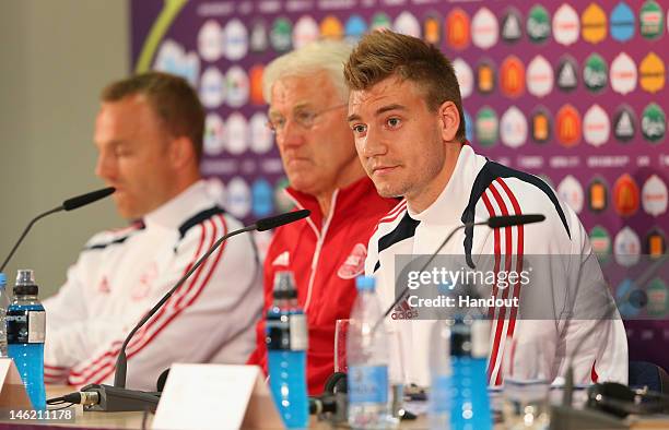 In this handout image provided by UEFA, Lars Jacobsen, Morten Olsen the coach of Denmark and Nicklas Bendtner face the media during a UEFA EURO 2012...